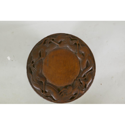 1143 - A C19th colonial carved hardwood occasional table with dragon decoration, 51cm high x 51cm diameter