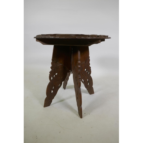 1143 - A C19th colonial carved hardwood occasional table with dragon decoration, 51cm high x 51cm diameter