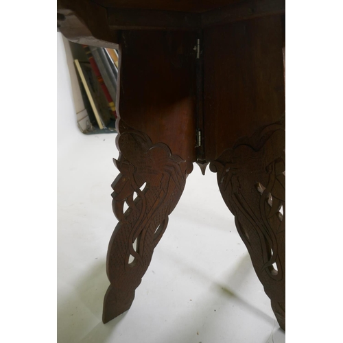 1143 - A C19th colonial carved hardwood occasional table with dragon decoration, 51cm high x 51cm diameter