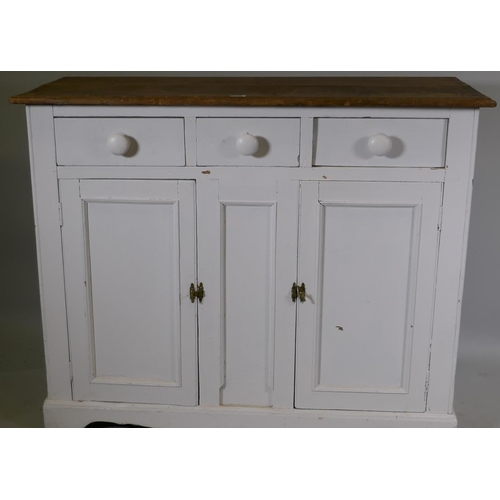 1145 - A C19th painted pine dresser base, with satin walnut top over three drawers and two cupboards, raise... 