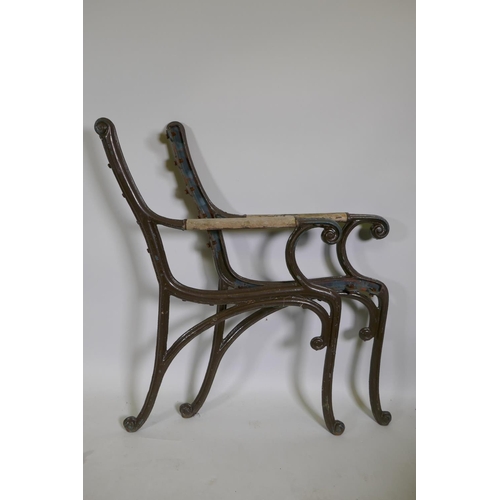 1148 - A pair of wrought iron garden bench ends, 84cm high