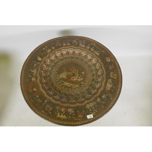 1149 - A vintage Indian brass tray with engraved and enamelled decoration, on a carved folding wood stand, ... 