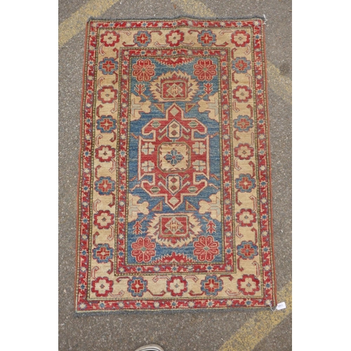 1160 - A Russian blue ground wool Kazak rug with cream borders, 88 x 136cm