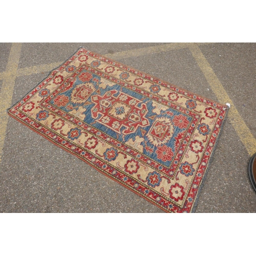 1160 - A Russian blue ground wool Kazak rug with cream borders, 88 x 136cm