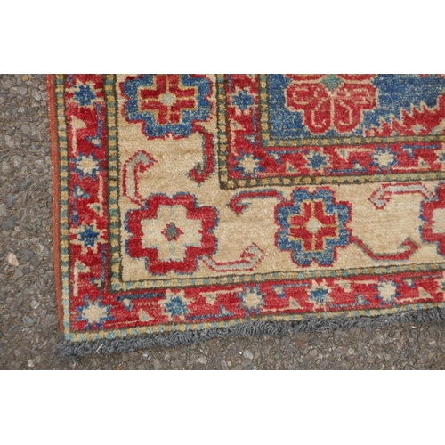 1160 - A Russian blue ground wool Kazak rug with cream borders, 88 x 136cm