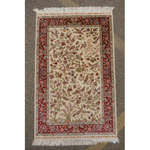 1164 - A Turkish cream ground silk hereke hanging rug with red borders, 78 x 124cm