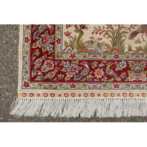 1164 - A Turkish cream ground silk hereke hanging rug with red borders, 78 x 124cm