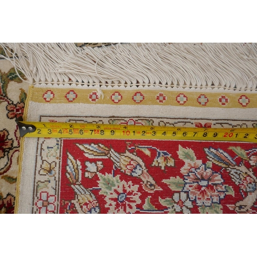 1164 - A Turkish cream ground silk hereke hanging rug with red borders, 78 x 124cm