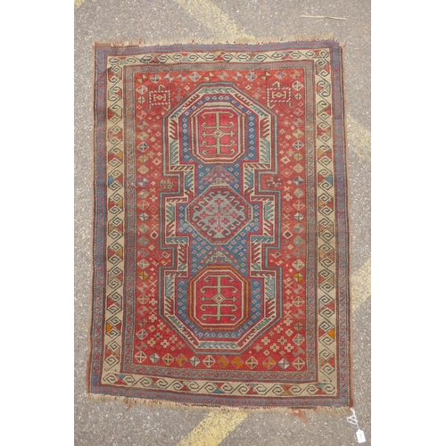 1165 - An antique Caucasian red ground wool Shirvan rug, 96 x 138cm