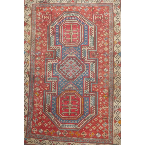 1165 - An antique Caucasian red ground wool Shirvan rug, 96 x 138cm