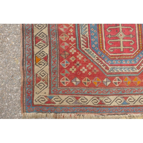 1165 - An antique Caucasian red ground wool Shirvan rug, 96 x 138cm