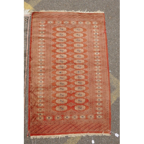 1168 - A terracotta ground Bokhara wool rug, 94 x 150cm, and an Afghan Jalder pink ground rug, 94 x 150cm, ... 