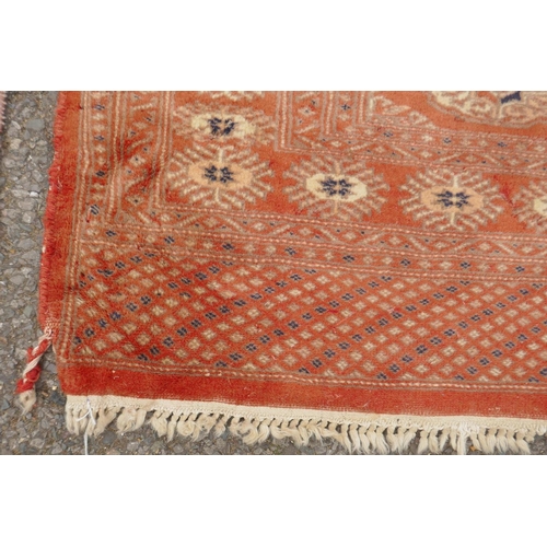 1168 - A terracotta ground Bokhara wool rug, 94 x 150cm, and an Afghan Jalder pink ground rug, 94 x 150cm, ... 