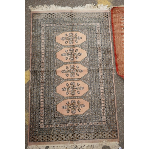 1168 - A terracotta ground Bokhara wool rug, 94 x 150cm, and an Afghan Jalder pink ground rug, 94 x 150cm, ... 