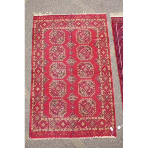 1169 - A red ground Turkman rug, 125 x 162cm, and another red ground Persian design rug, 117 x 182, AF