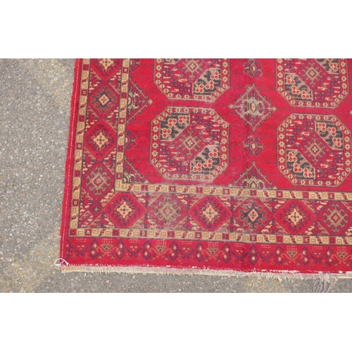 1169 - A red ground Turkman rug, 125 x 162cm, and another red ground Persian design rug, 117 x 182, AF