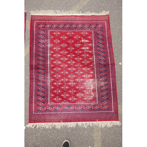 1169 - A red ground Turkman rug, 125 x 162cm, and another red ground Persian design rug, 117 x 182, AF