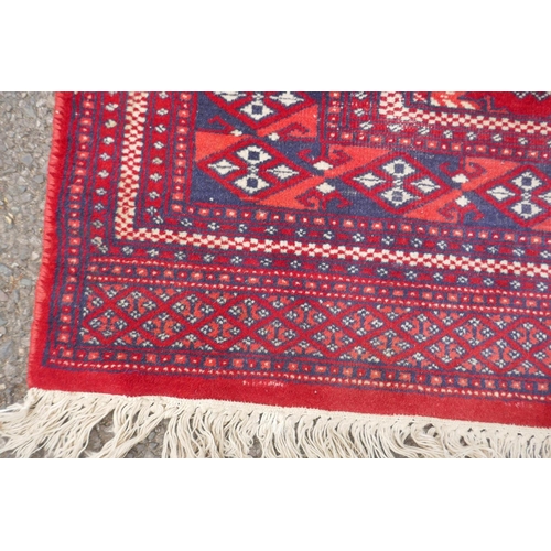 1169 - A red ground Turkman rug, 125 x 162cm, and another red ground Persian design rug, 117 x 182, AF