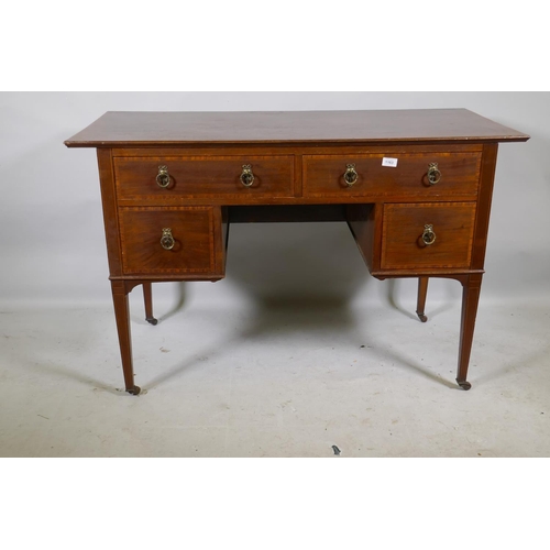 1219 - A Victorian mahogany kneehole desk with satinwood banding inlay and brass handles, four drawers rais... 