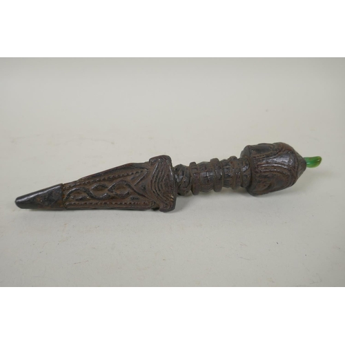 125 - A Tibetan carved hardwood ceremonial phurba with a metal tip and inset green jade stone, 22cm