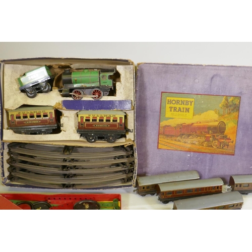 126 - A quantity of Trix Twin Railway track, rolling stock, Pullman carriages and two locomotives, buildin... 