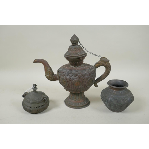 140 - An antique Indian bronze Dhokra money box, and Indian repousse bronze port, and a Tibetan copper tea... 