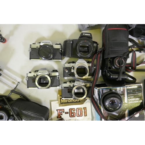 148 - A quantity of 35mm cameras, Pentax and Olympus bodies, Prinzlux binoculars, camera equipment, flashe... 