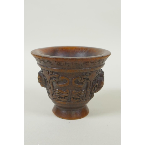 153 - A Chinese faux horn libation cup with twin kylin handles, seal mark to base, 8cm high x 10cm diamete... 