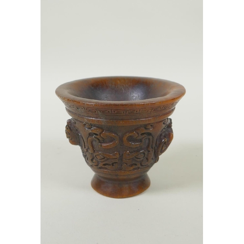 153 - A Chinese faux horn libation cup with twin kylin handles, seal mark to base, 8cm high x 10cm diamete... 