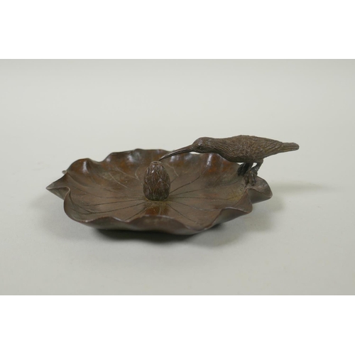 155 - An Oriental bronze incense holder in the form of humming bird on a lotus flower, mark to base, 10cm ... 