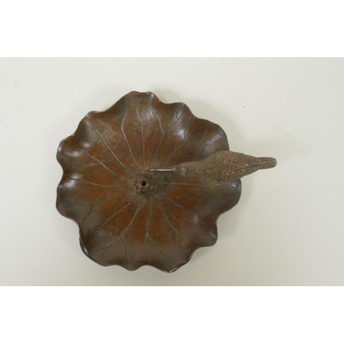 155 - An Oriental bronze incense holder in the form of humming bird on a lotus flower, mark to base, 10cm ... 