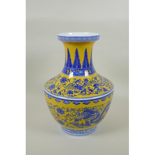 158 - A Chinese blue and white porcelain vase with dragon, phoenix and lotus flower decoration on a yellow... 