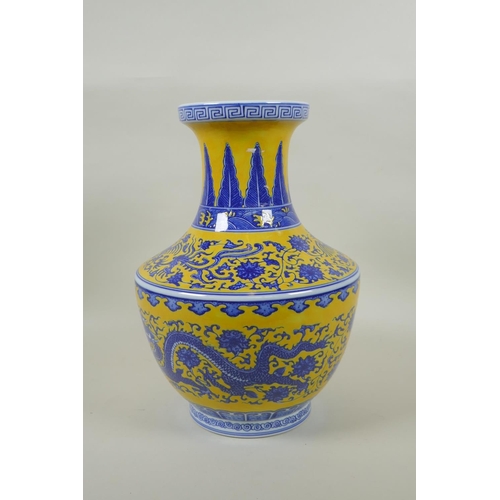 158 - A Chinese blue and white porcelain vase with dragon, phoenix and lotus flower decoration on a yellow... 