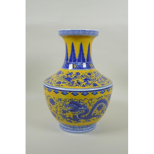 158 - A Chinese blue and white porcelain vase with dragon, phoenix and lotus flower decoration on a yellow... 