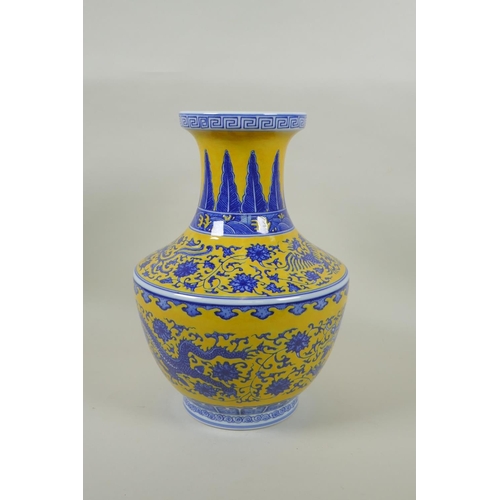 158 - A Chinese blue and white porcelain vase with dragon, phoenix and lotus flower decoration on a yellow... 