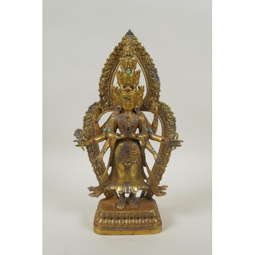 162 - A Tibetan gilt bronze figure of Avalokiteshvara, set with multi-colour hardstones, 28cm high