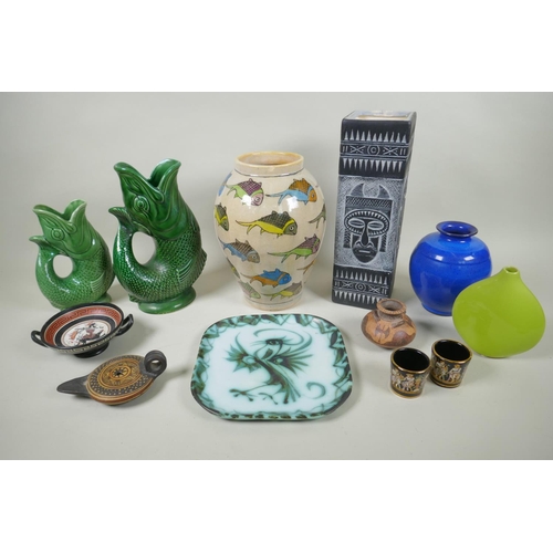 164 - A quantity of assorted pottery to include a Persian faience fish vase, two Dartmouth fish jugs, a Ne... 