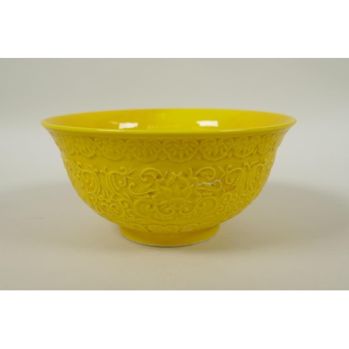 166 - A Chinese yellow ground porcelain rice bowl with raised lotus flower decoration, YongZheng 6 charact... 