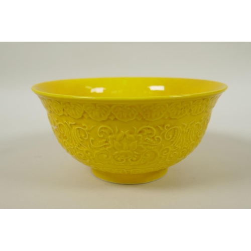 166 - A Chinese yellow ground porcelain rice bowl with raised lotus flower decoration, YongZheng 6 charact... 