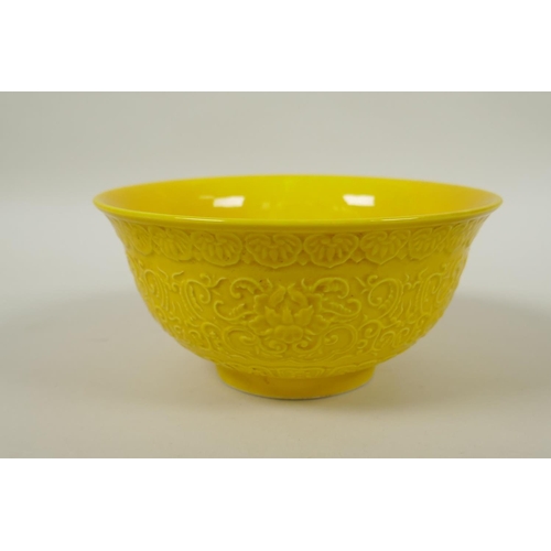 166 - A Chinese yellow ground porcelain rice bowl with raised lotus flower decoration, YongZheng 6 charact... 