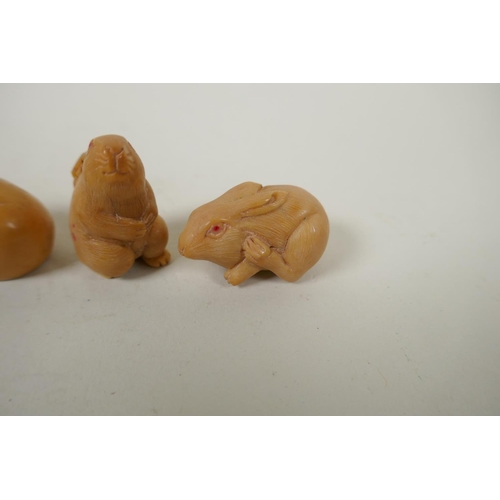 167 - Four Japanese carved tagua nut netsuke in the form of three rabbits and chick, largest 4cm