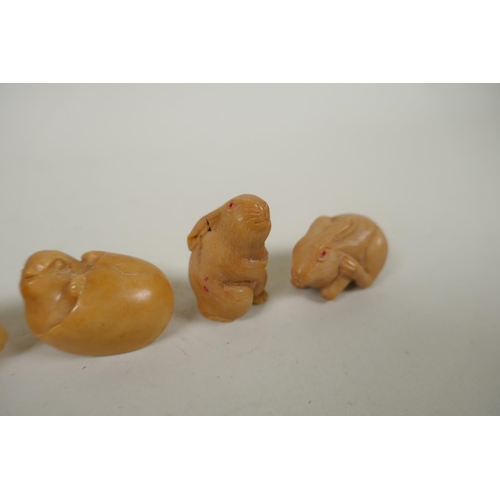 167 - Four Japanese carved tagua nut netsuke in the form of three rabbits and chick, largest 4cm