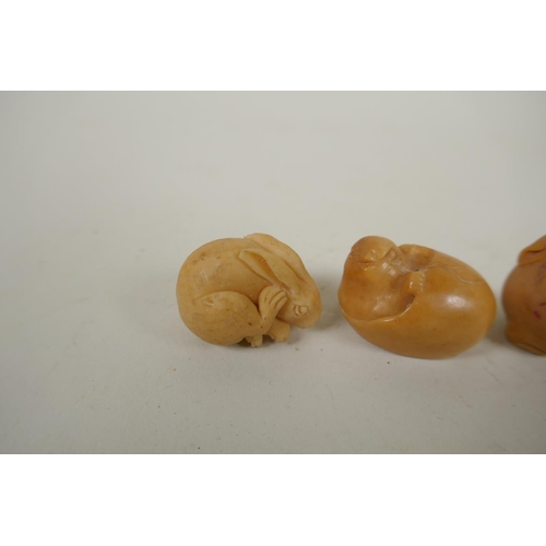 167 - Four Japanese carved tagua nut netsuke in the form of three rabbits and chick, largest 4cm