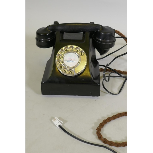 169 - A vintage bakelite telephone