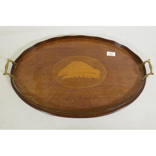 172 - An Edwardian mahogany oval serving tray with shaped gallery, brass handles and shell inlaid decorati... 