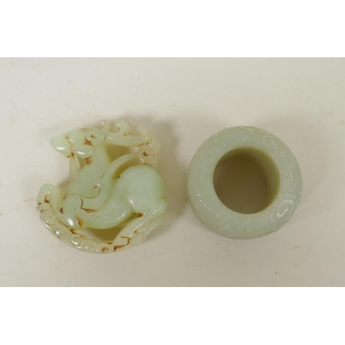 178 - A Chinese carved celadon jade rondel in the form of a deer, and a jade archer's thumb ring, 5cm diam... 