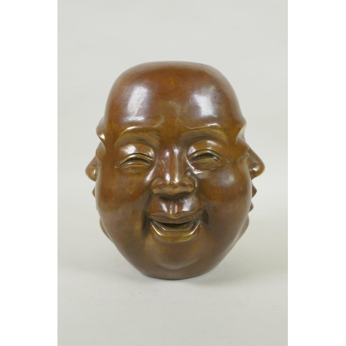 180 - A Chinese filled bronze four face Buddha head, seal mark to base, 20cm high