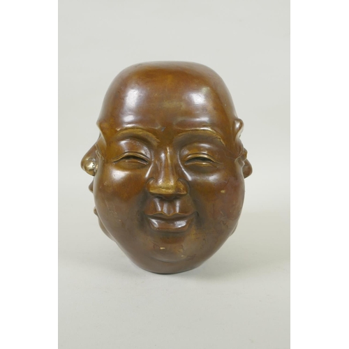 180 - A Chinese filled bronze four face Buddha head, seal mark to base, 20cm high