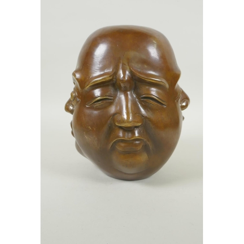 180 - A Chinese filled bronze four face Buddha head, seal mark to base, 20cm high