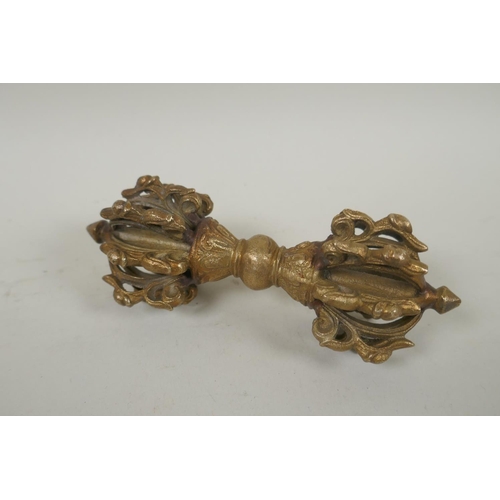 182 - A Tibetan gilt bronze vajra, 15cm long, and a white metal mirror and zodiac calendar